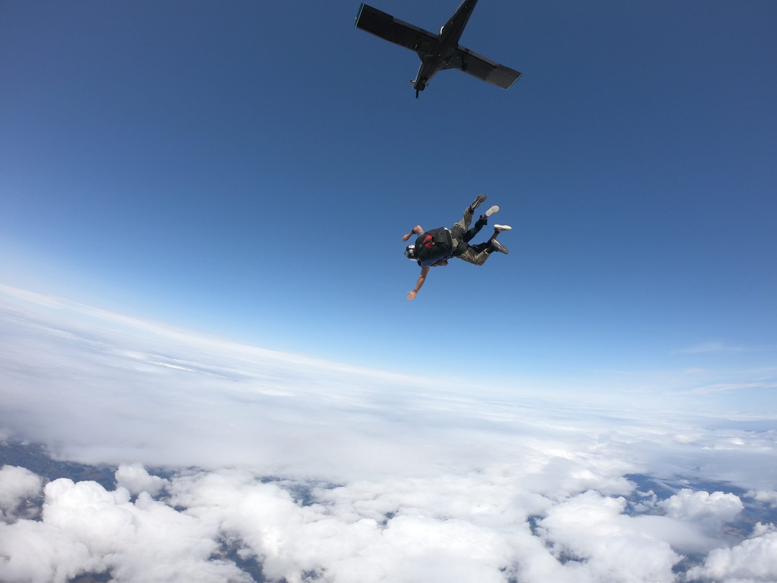 A picture of a person doing tandem skydiving.